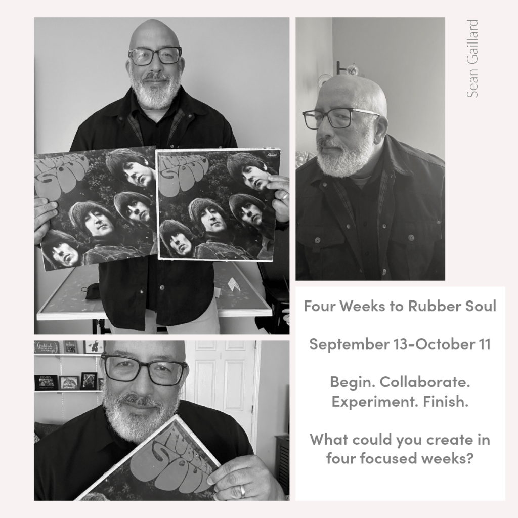 A man with a beard and glasses holds up two copies of the album 'Rubber Soul' by The Beatles, standing in a room with a light background.